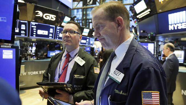 Traders Edward Curran, left, and Michael Smyth on the floor of the New York Stock Exchange on Friday as shares moved broadly lower.