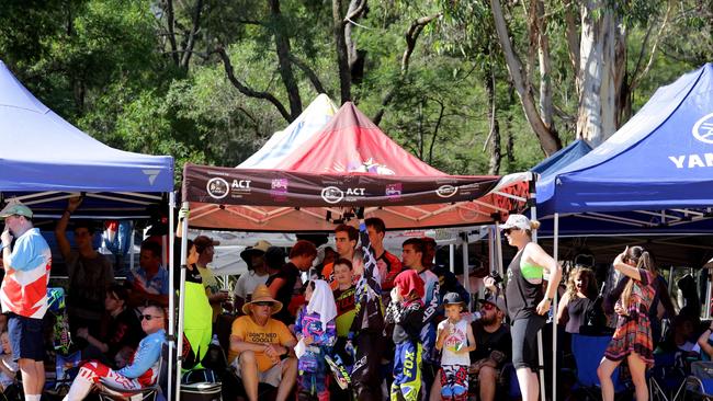 Spectators keep cool under tents during the hot and humid day.