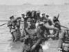 The Divisional Headquarters Staff wading ashore at Anzac Cove. The officer with the spade is thought to be Major Cecil Henry Foott DAQMG (Later Brigadier CH Foott CB CMG). Pic: Courtesy AWM G00903