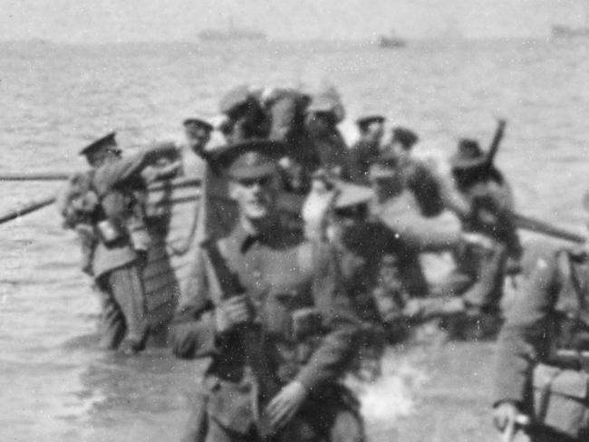 The Divisional Headquarters Staff wading ashore at Anzac Cove. The officer with the spade is thought to be Major Cecil Henry Foott DAQMG (Later Brigadier CH Foott CB CMG). Pic: Courtesy AWM G00903