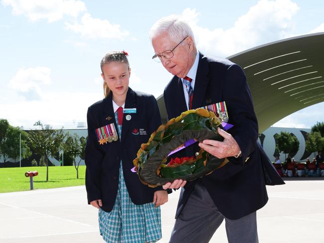 Don Tait laying a wreath with student Tianna Knight.