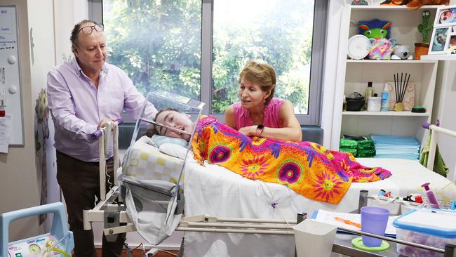 Jess Schonberger in her bedroom with her parents Debbie and Earl. Picture: John Feder