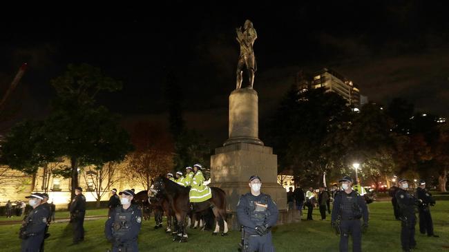 Police guard a statue of James Cook in Sydney last week. Picture: AP