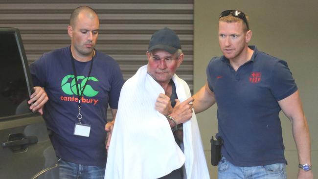 Gino Stocco is escorted by two policemen into Dubbo police station. Picture: AAP