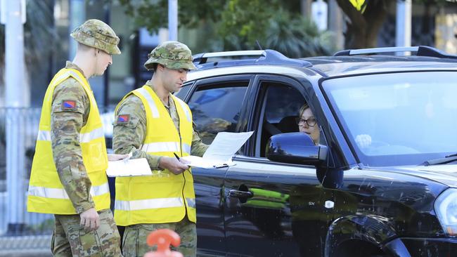 Australian Defence Force personnel assist Queensland police at the Griffith St checkpoint. Picture: Scott Powick.