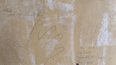 The removal of wallpaper revealed hand prints from a previous owner dating back to 1953. Picture: Cobi Christian