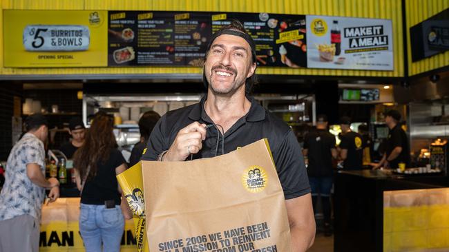 Ben Nicol with a bag of Burritos as Guzman Y Gomez Opens its door, Stuart Park, Darwin. Picture: Pema Tamang Pakhrin