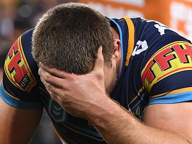 Jai Arrow  of the Titans (right)  is dejected following the Round 9 NRL match between the Gold Coast Titans and the Cronulla Sharks at Suncorp Stadium in Brisbane, Thursday, May 9, 2019.  (AAP Image/Dave Hunt) NO ARCHIVING, EDITORIAL USE ONLY