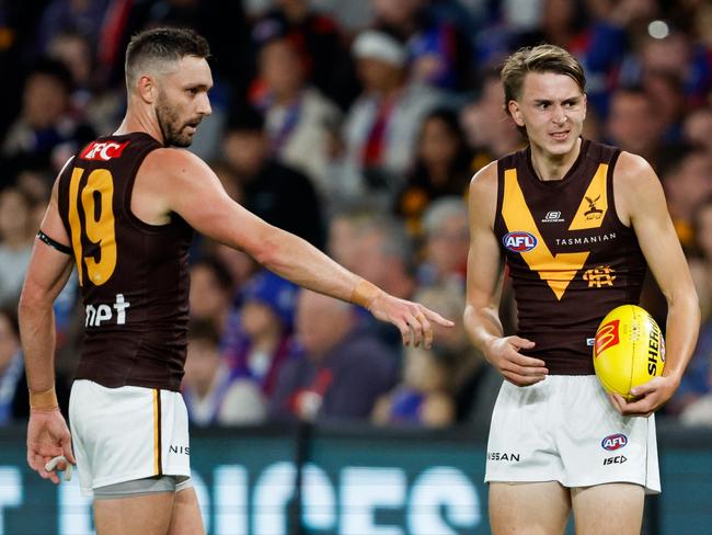 Hawthorn debutant Calsher Dear speaks with teammate Jack Gunston before kicking the first goal of his career in Round 8. Picture: Dylan Burns/AFL Photos via Getty Images.