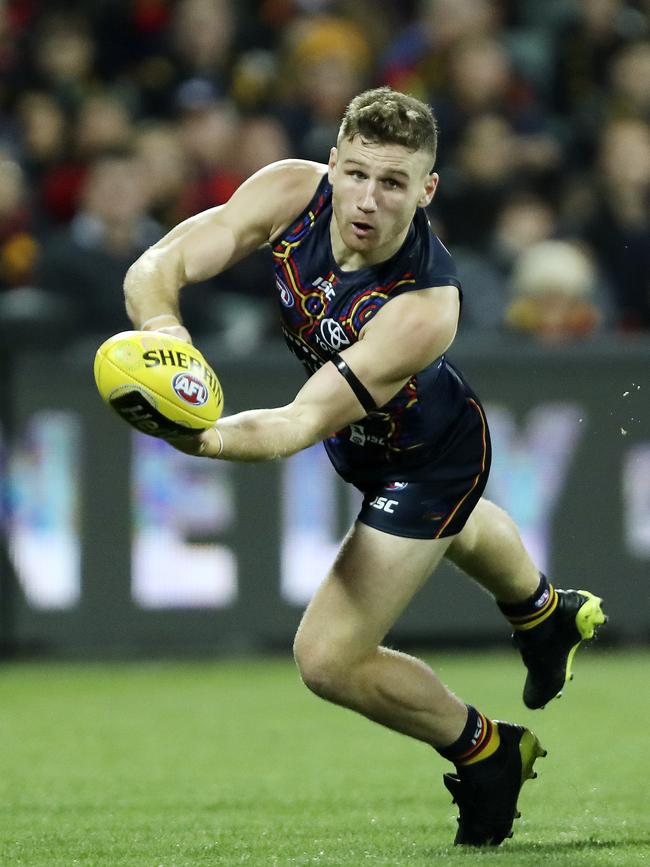 Adelaide’s Rory Laird fires the handball forward. Picture Sarah Reed