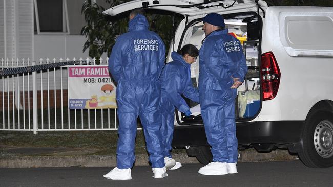 Forensic officers at Cabramatta last night.  Picture: Gordon McComiskie