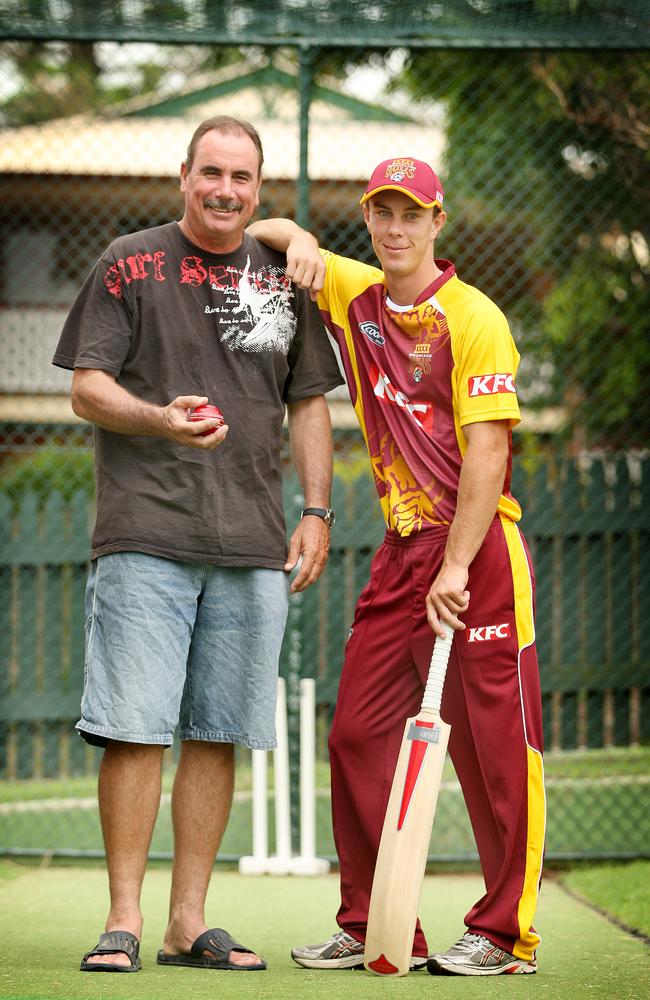 Chris Lynn with his father Colin in the net Colin built in their yard.