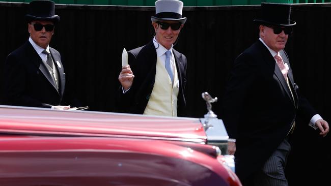 Racegoers walk by a Rolls-Royce in the carpark at Royal Ascot. Picture: AFP