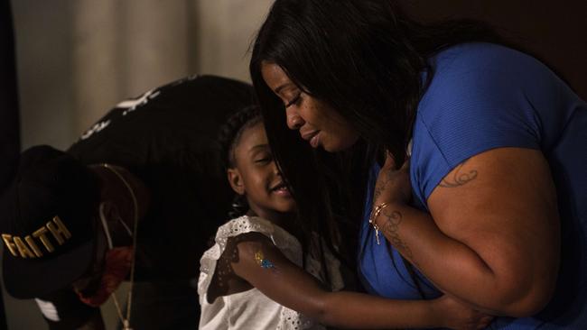 Roxie Washington embraces her daughter Gianna Floyd at a press conference in St. Paul, Minnesota.