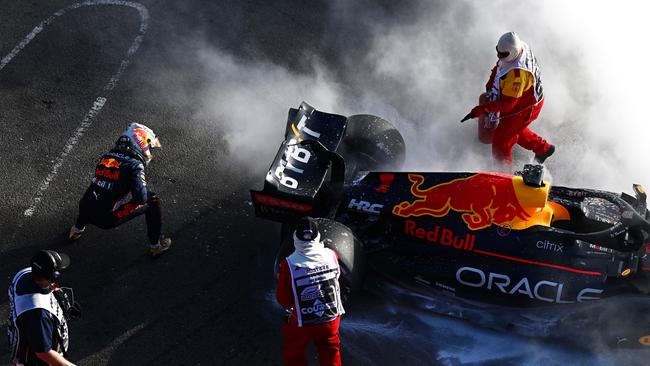 Max Verstappen looks on as his car goes up in flames. Picture: Getty