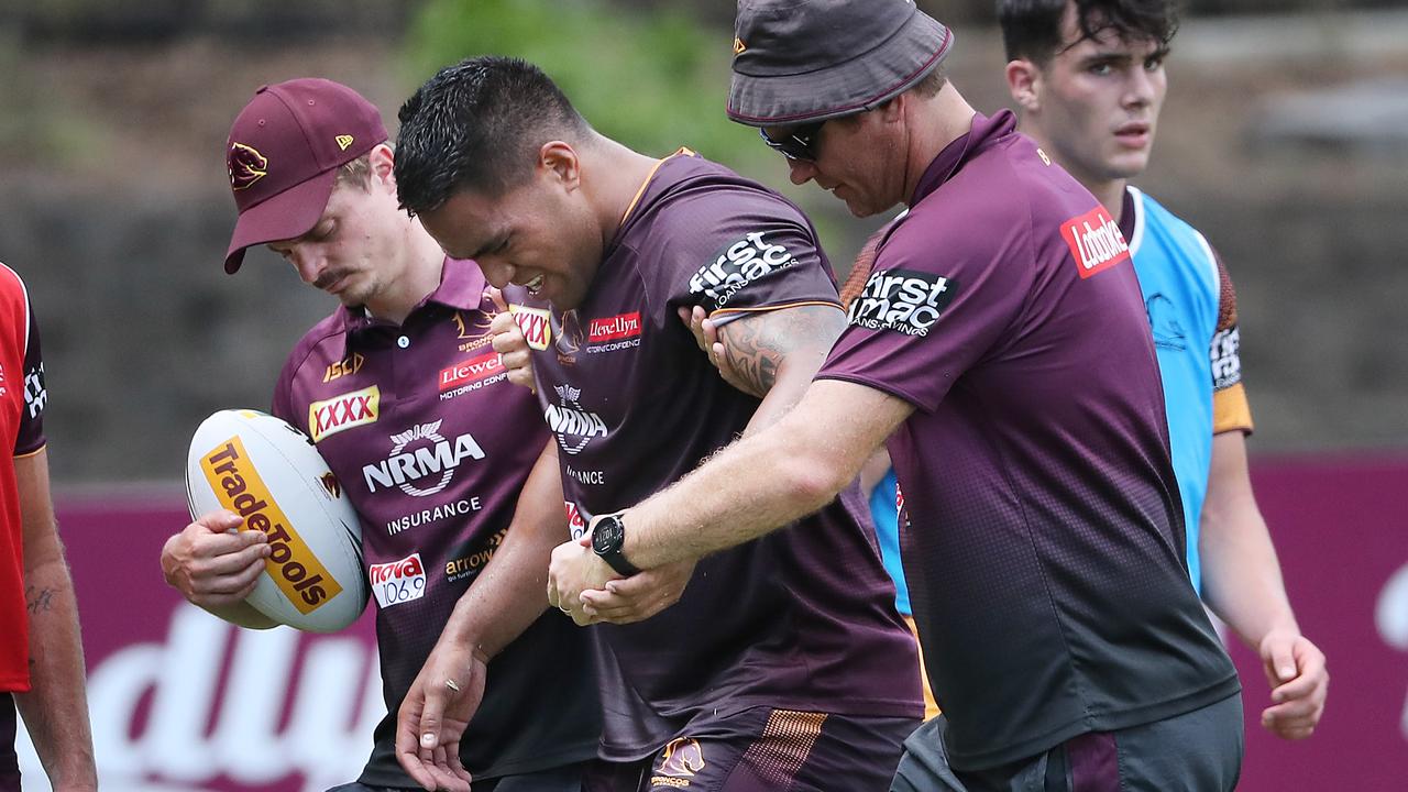 Joe Ofahengaue leaves the field injured during the Broncos intense training session at Red Hill today. 