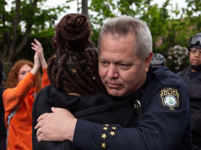 Bellevue Police Chief Steve Mylett hugs a demonstrator during a gathering to protest the death of George Floyd. Picture: AFP