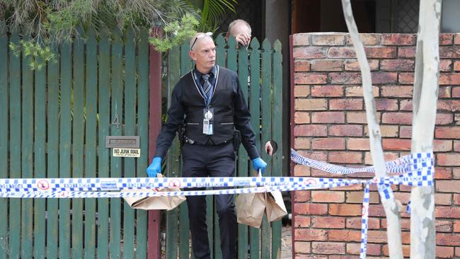 An officer leaves the house. Picture: Peter Wallis