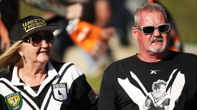 A fan wears a Western Suburbs jersey and another a tribute T-shirt to Tommy Raudonikis. Picture: Getty Images