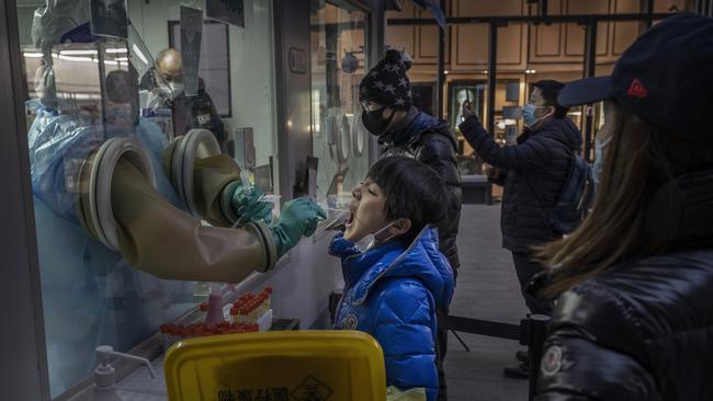 A boy is swabbed by a health worker during a nucleic acid test for Covid-19 at a private testing site on January 17, 2022 in Beijing, China. Picture: Getty