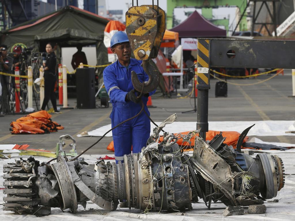 Officials move an engine recovered from the crashed Lion Air jet for further investigation. Picture: Achmad Ibrahim