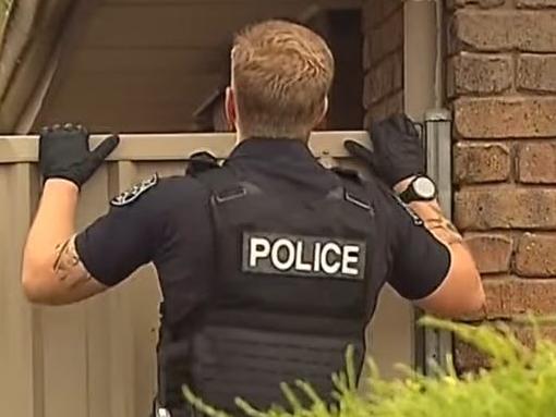 Heavily armed STAR Group officers have swooped on a home at Reynella East, arresting an alleged gunman. Picture: 7NEWS
