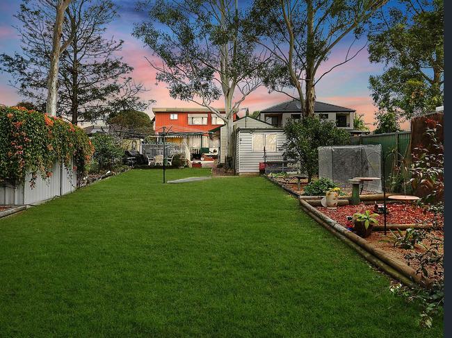 The backyard has a deep lawn area.