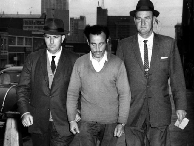 Detective sergeants James Black and Jack Ford bring William McDonald to police headquarters in Russell Street, Melbourne, after his arrest.