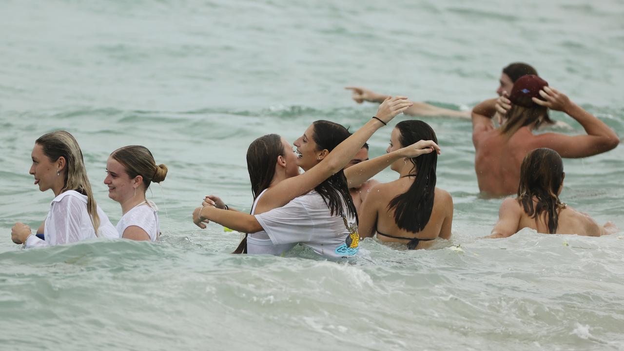 Family and friends of 16-year-old alleged stabbing victim Balin Stewart gather to pay tribute on his home beach at Buddina. Picture: Lachie Millard