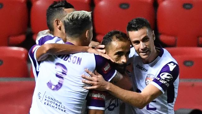 Empty seats: Perth Glory’s Diego Castro (second from right) celebrates a goal in a 2-0 win over Adelaide United at Coopers Stadium last Friday. Picture: Mark Brake/Getty Images