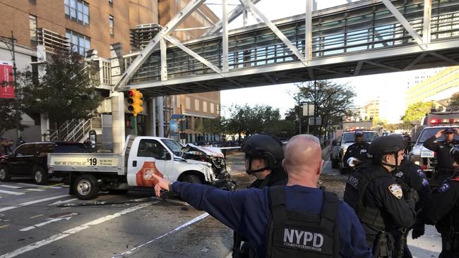 New York City Police Officers respond to report of gunfire along West Street near the pedestrian bridge at Stuyvesant High School in lower Manhattan. Picture: AP