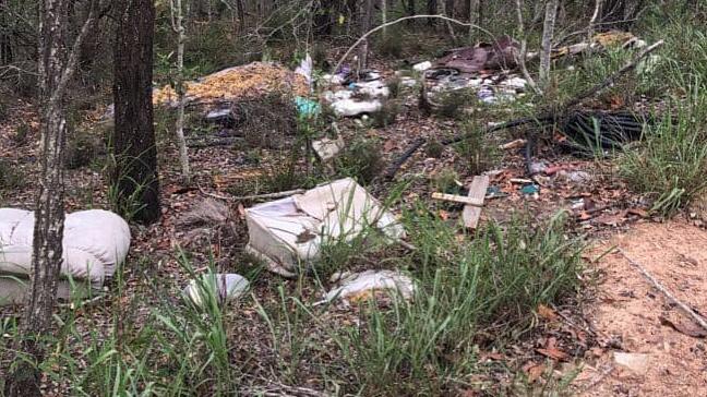 Illegal dumpers leave trails of rubbish through the woodland.