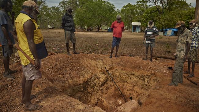 Guyula (red shirt) attends a funeral in Gapuwiyak. Picture: Rebecca Parker