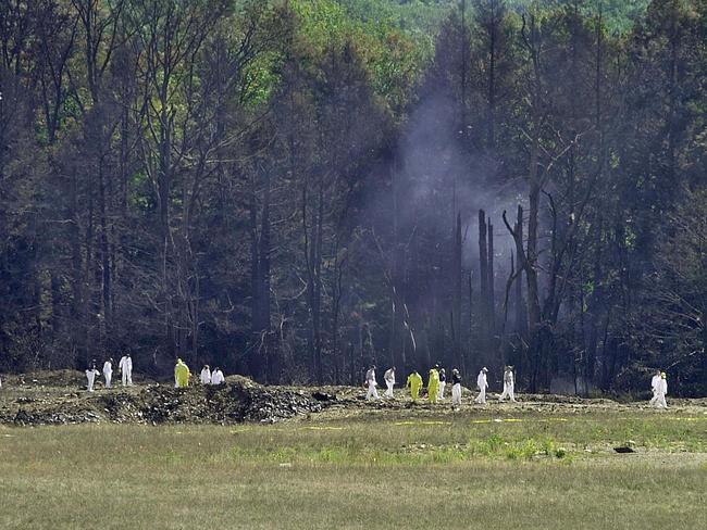 Investigative personnel search the crash site of United Airlines Flight 93 looking for debris and evidence, including the plane's flight recorder, on 12 September 2001 in Shanksville, Pennsylvania. Picture: David Maxwell