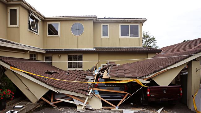 Debra Kasmar and her dad Bryan Page out the front of their collapsed carport. Picture: Adam Yip / Manly Daily