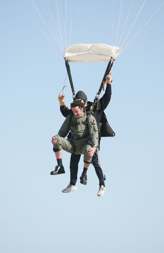 Rodney Dedman and the other members of the bridal party skydived in their suits to the wedding at Point Cartwright. Picture: Anthony Reginato