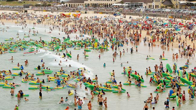 Beachgoers ride inflatable thongs as they celebrate Australia Day at Bondi Beach. (Photo by Brendon Thorne/Getty Images)