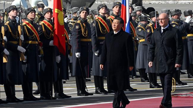 China's President Xi Jinping, accompanied by Russian Deputy Prime Minister Dmitry Chernyshenko, walks past honour guards during a welcoming ceremony. Picture: AFP