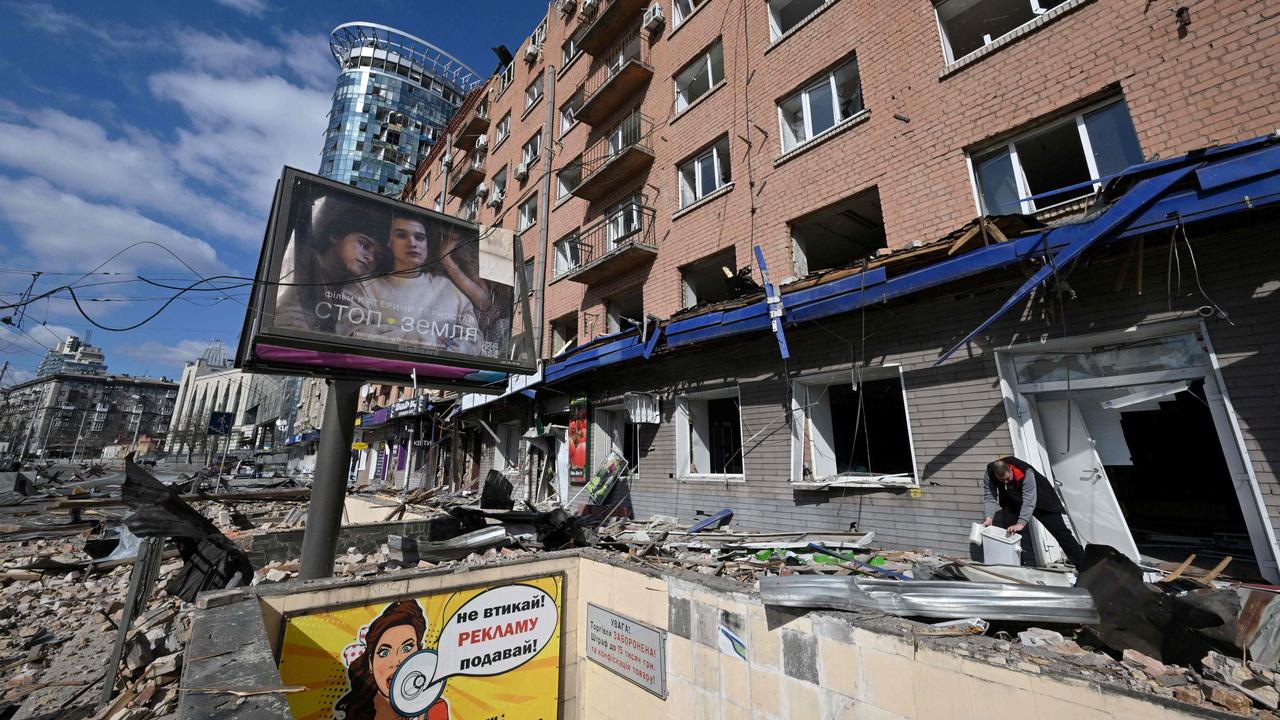 A man takes out the garbage from his cafe destroyed by shelling in Kyiv. Picture: Sergei SUPINSKY / AFP