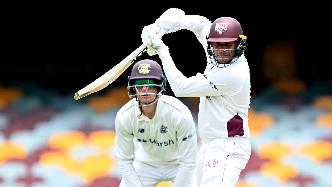 Usman Khawaja plays a square drive as bat-pad fielder Cameron Bancroft watches on in the Sheffield Shield clash between Queensland and WA at the Gabba. Picture: Bradley Kanaris / Getty Images