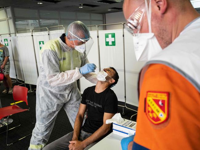 Medical workers at a COVID-19 testing site at the arrivals area of a French airport. Picture: AFP