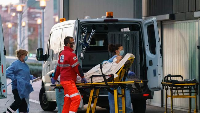 Paramedics wheel a patient into the Burgos general hospital. Spain has joined Italy in seeing its number of fatalities overtake China, where the virus first emerged just three three months ago.