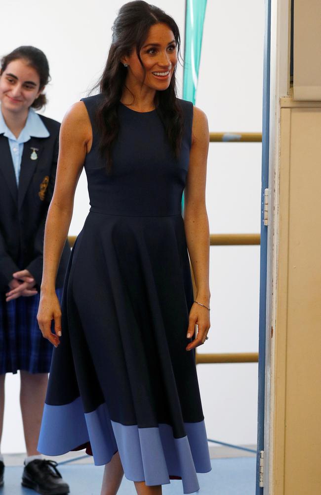Meghan went full high school chic with her hair, sporting the half up-do and strands at the front.