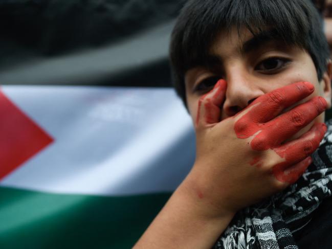 A member of the Palestinian community in Chile takes part in a protest outside the Israeli Embassy against its military operations in Gaza.