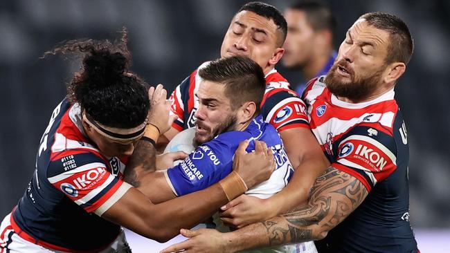 Corey Allan is greeted by half of the Roosters pack.