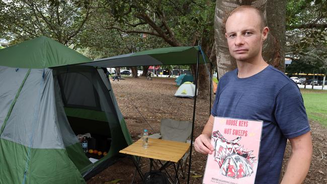 Michael Vogler with the sign he leaves in his tent, the council has tried to remove it twice. Picture: Liam Kidston