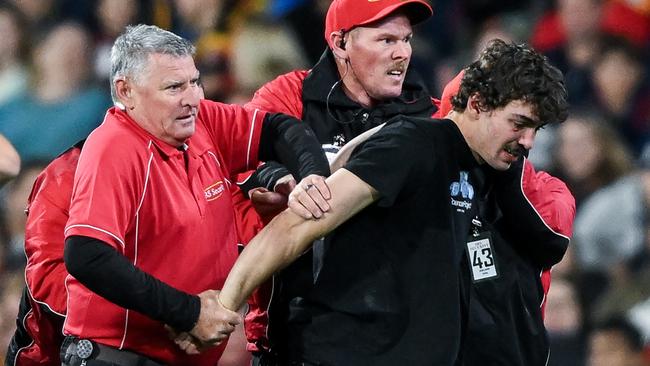 Security escorting the man off the pitch. Picture: Mark Brake/Getty Images