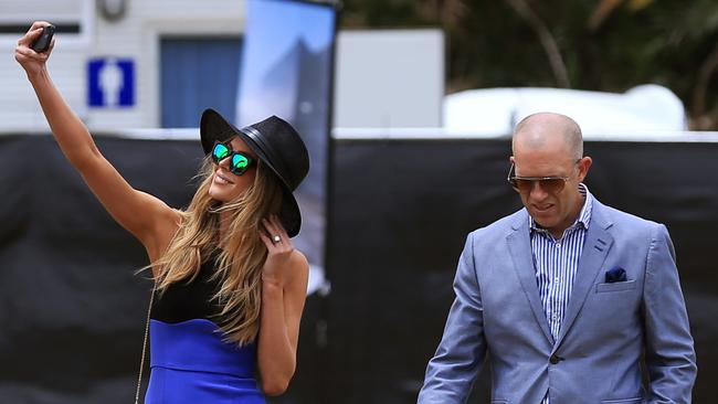 Jennifer Hawkins takes a selfie as she arrives at the Land Rover marquee with her manager Sean Anderson at Polo in the City event. Picture: Toby Zerna