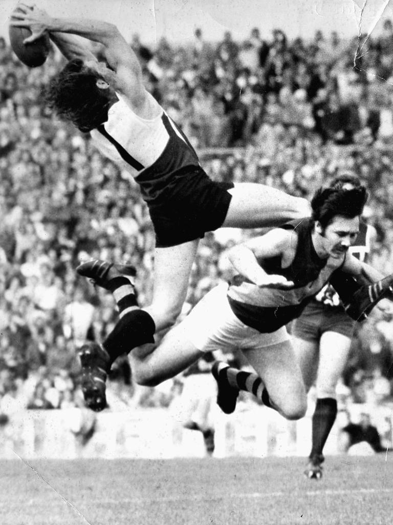 Russell Ebert crashes into Glenelg's Peter Marker to claim a mark in 1974 preliminary final at Football Park.