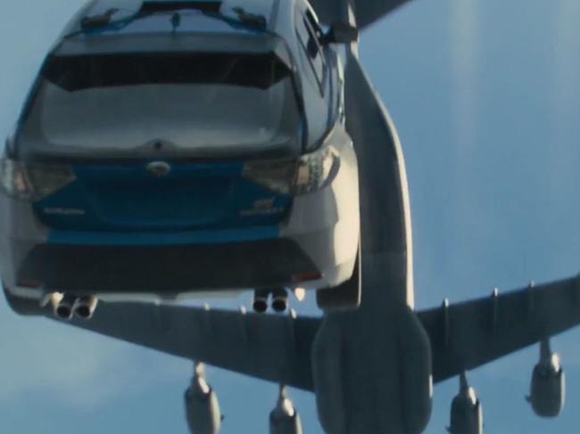 Totally over the top ... Paul Walker, Van Diesel, Tyrese Gibson, Ludacris and Michelle Rodriguez all drop out of a cargo plane in their cars in the new Furious 7 trailer. Picture: YouTube